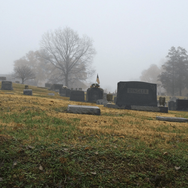 American flag in cemetery in fog